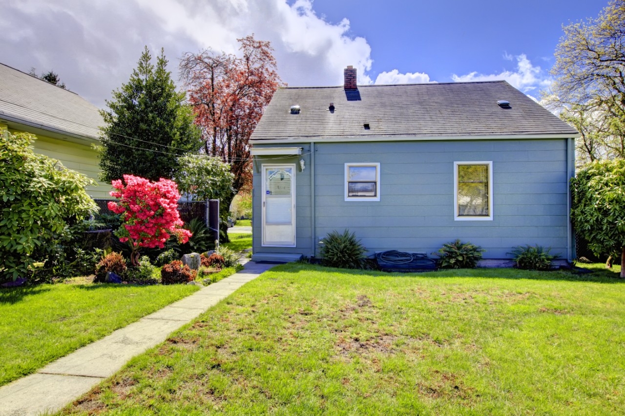 Blue house with grassy front yard