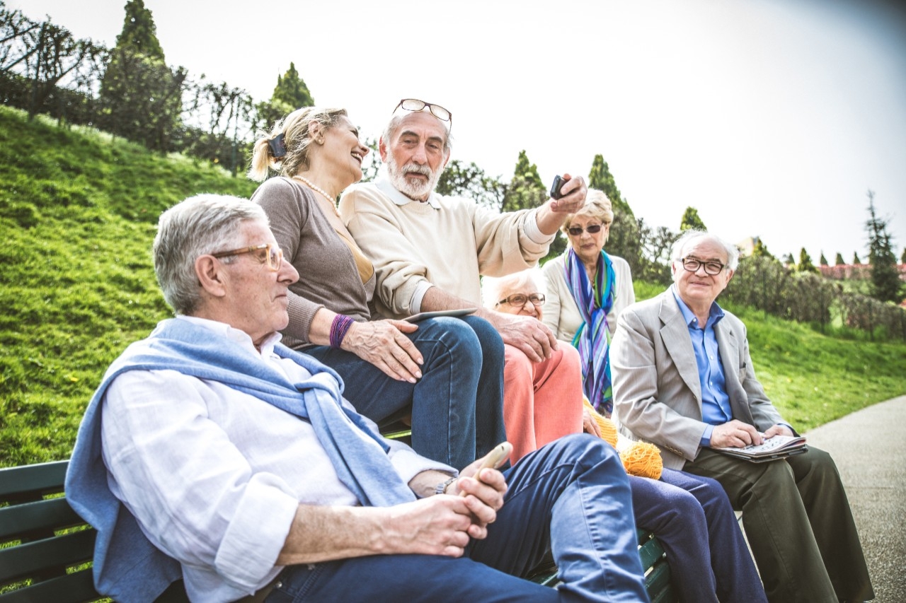 Group of seniors on park bench