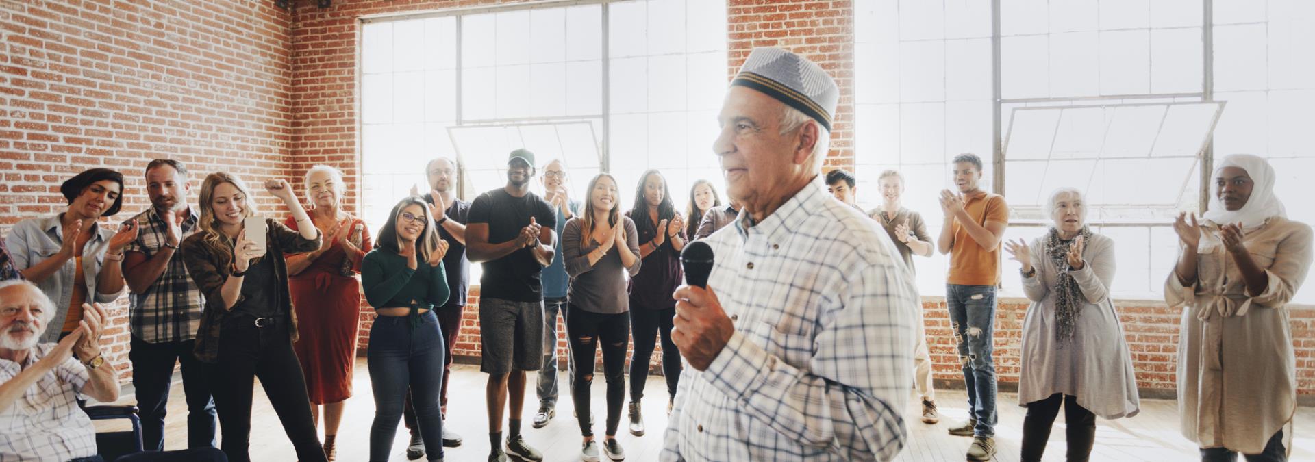Man speaking to a small group of community members