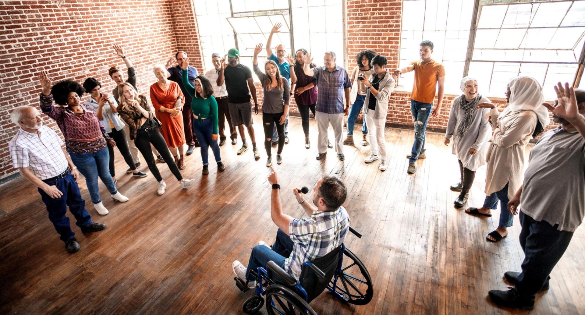 Group of community members in a circle answering questions and raising their hands