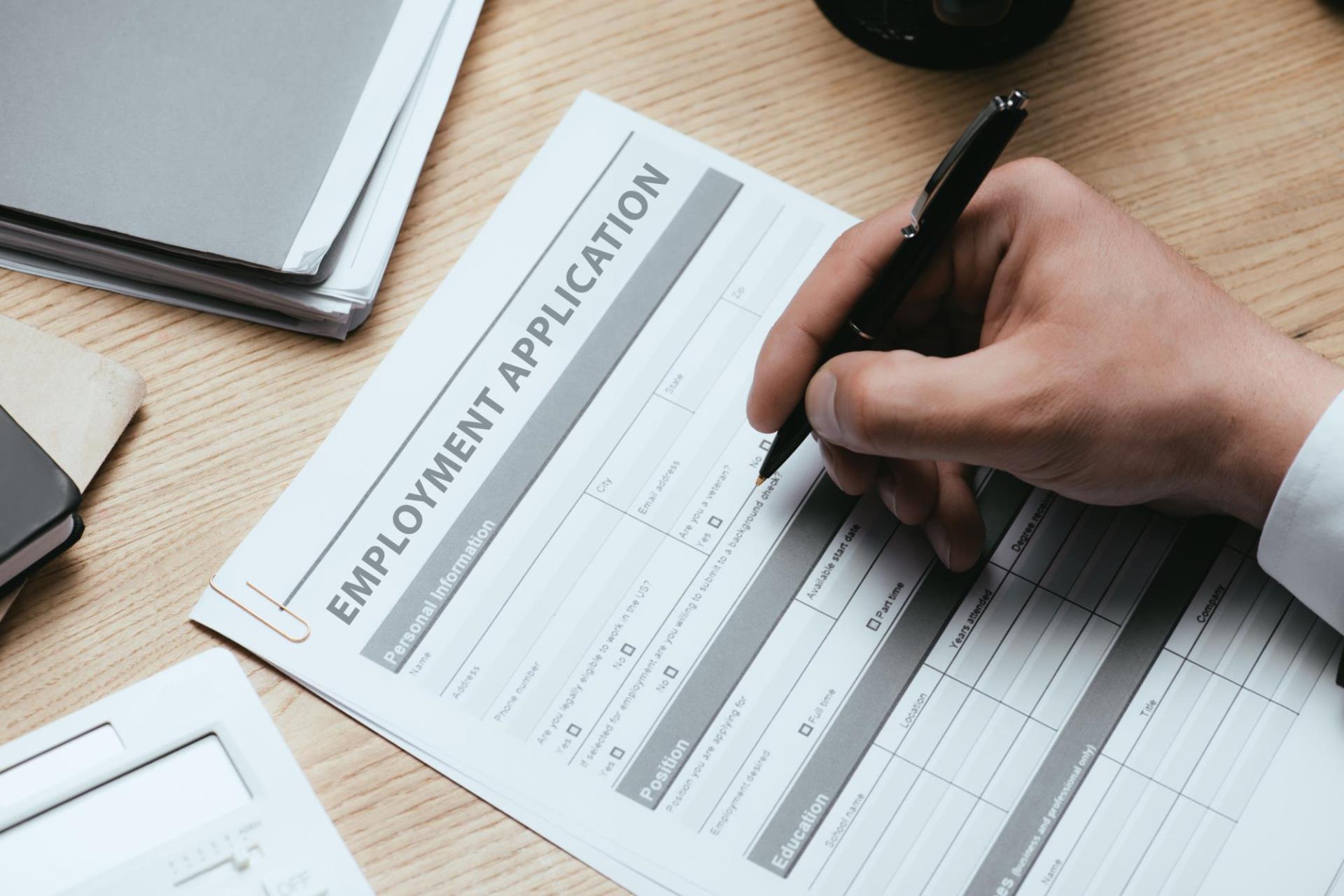 cropped-view-of-man-filling-in-employment-applicat-2022-12-16-16-44-26-utc