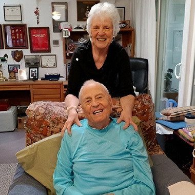 ElderHelp Volunteer Judi Graham smiles as she visits with senior Gilbert Olsen