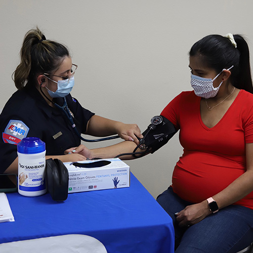 pregnant woman getting blood pressure checked